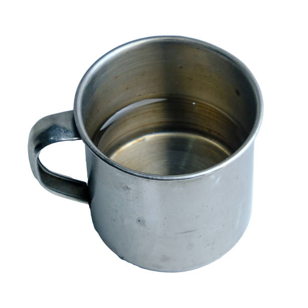 Close-up of a stainless steel mug with water, showcasing simplicity and functionality of design.