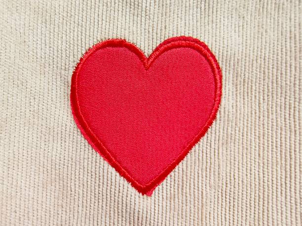 istock Red heart shape wool on beige Corduroy fabric texture. 2202795522