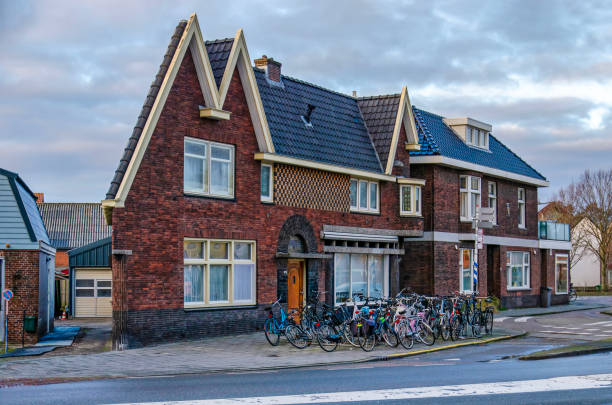 Delfgauw, The Netherlands, January 12, 2025: oddly shaped group of houses with bicycles parked in front, in a curve of the road