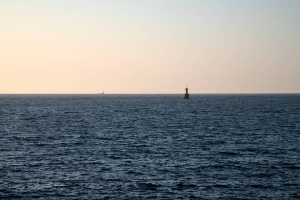 istock beacon on the sea during sunset 2202799056