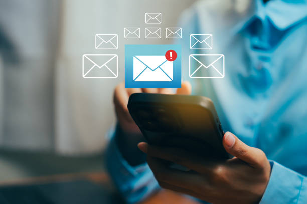 istock Person Checking Mobile Phone for New Messages and Notifications on a Bright Desk Background, Business concept. 2202802267