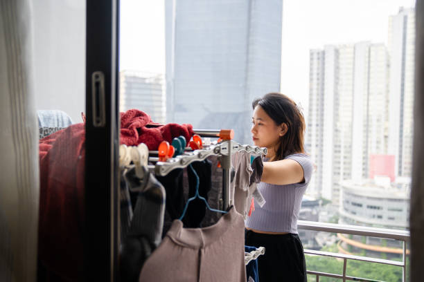 Singapore, Singapore - May 8, 2009: Clothes hanging on lines outside apartment windows in a high-rise building, reflecting the practical lifestyle in densely populated urban settings.