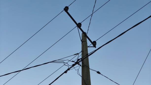 istock lamp poles and electric cables with morning sun atmosphere 2202804981