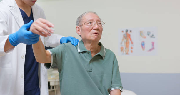 istock Asian Therapist Aids Arm Recovery 2202806530