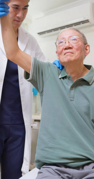 istock Asian Therapist Aids Arm Recovery 2202806585