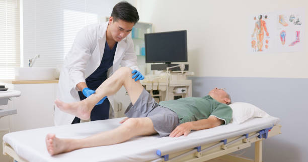 istock Asian Therapist Aids Leg Recovery 2202806908
