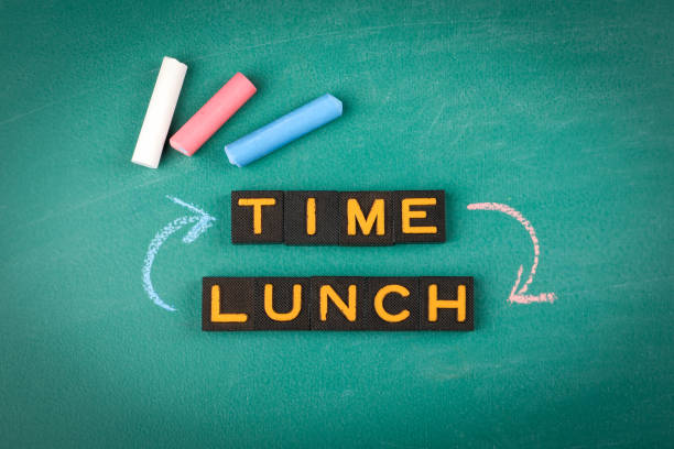 istock Lunch Time Concept with Chalkboard, Letter Blocks, and Colorful Chalk Sticks 2202808253