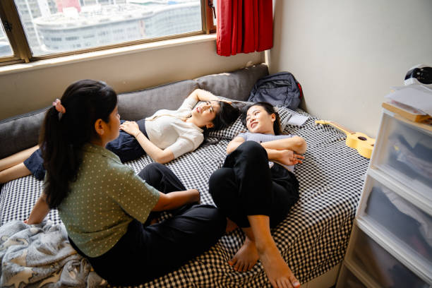 istock Young women playing and talking in bunk bed, at youth hostel 2202808905