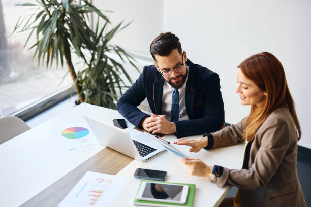 istock Business people discussing strategy in modern office using charts and laptop 2202813692