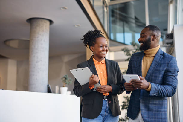 istock Business partners walking and talking in modern office building 2202814320