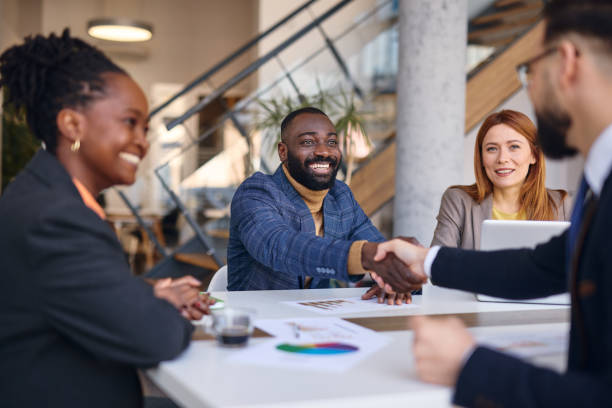 istock Business partners shaking hands during a meeting in a modern office 2202814379
