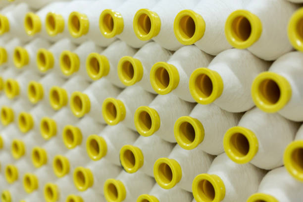 Colorful spools of thread, isolated on a white background. High angle view, studio shot.