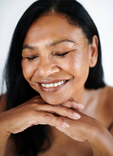 istock Beautiful Mature Woman Resting her Chin on her Hands while smiling 2202814888