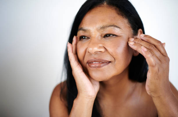 istock Smiling Mature Woman Enjoying Skincare Routine 2202814901