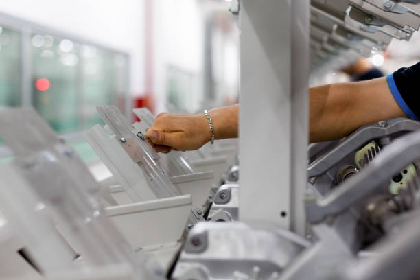 Worker maintaining machinery in a textile factory. Engineer worker work design program machine in textile factory. industry.