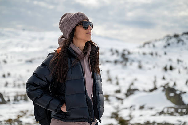 istock Hiker Woman with backpack in the winter mountain 2202816357