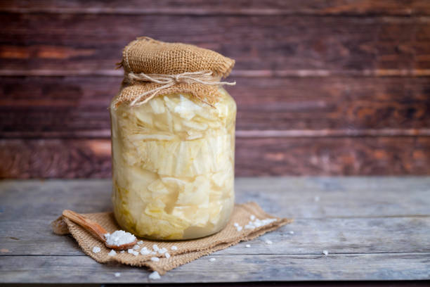 Pickled cabbage in a jar . Sauerkraut on woodens background