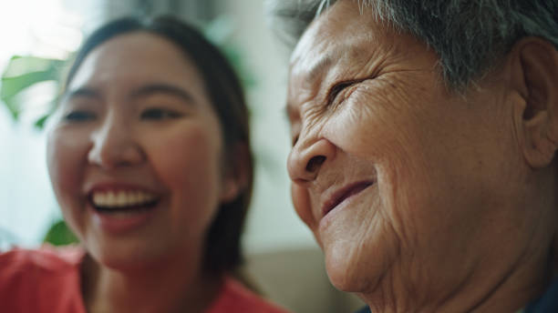 istock Elderly relax watching on a smartphone with her granddaughter. 2202817937