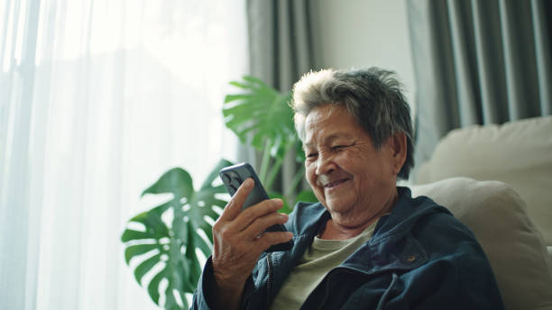 istock Elderly relax talking with ai voice assistant, chatbot. 2202817982