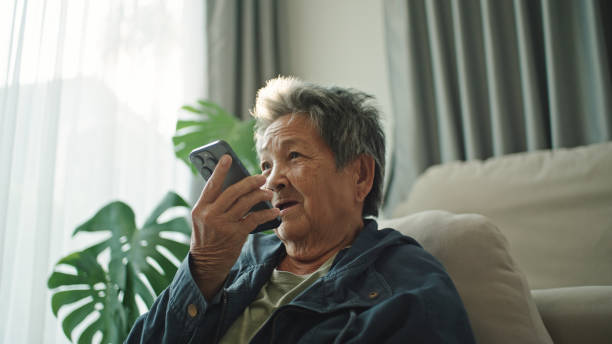 istock Elderly relax talking with ai voice assistant, chatbot. 2202817983