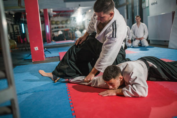 istock Two martial artists wearing traditional uniforms practice aikido 2202819783