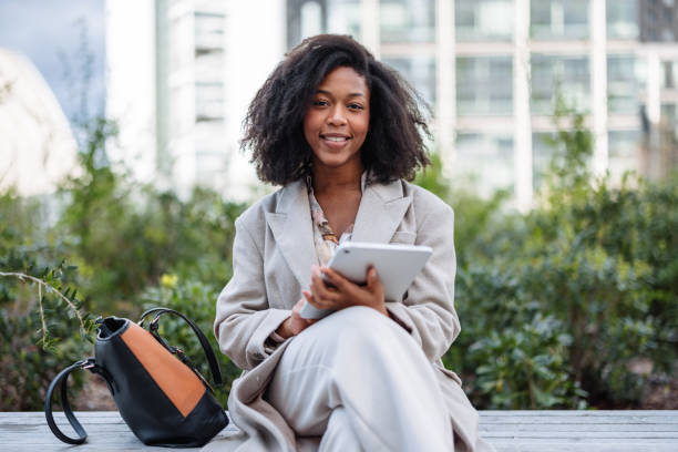 istock Cheerful Young Black Businesswoman Using Tablet Outside Office 2202823958