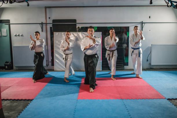 istock Front view of a group of fighters learning self-defense from an aikido trainer 2202826440