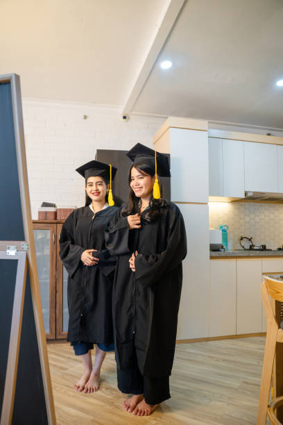 istock two young woman graduate getting ready looking at mirror at home 2202829339