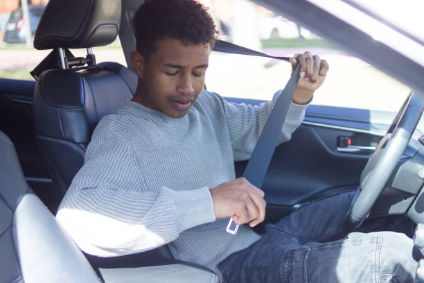 istock Driver buckling up inside his car for safety 2202830376