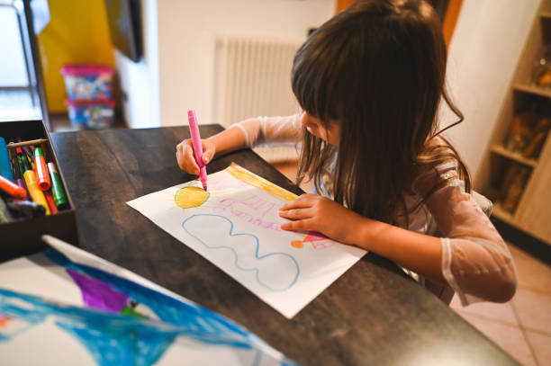 istock Close up of child drawing with felt tip pen 2202832217
