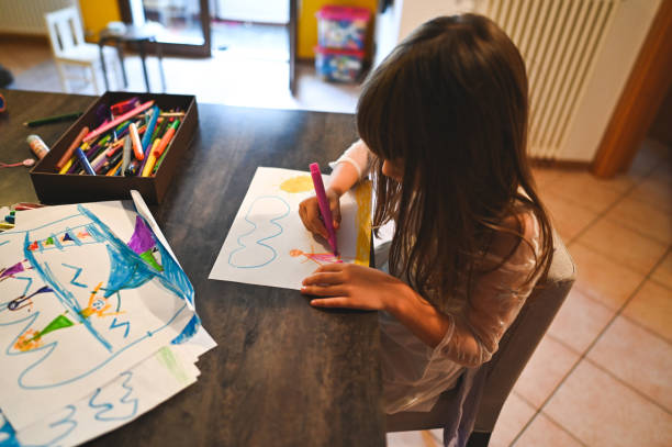 istock drawing sun and clouds on white paper 2202832270