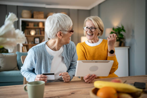 istock Two senior women making online purchases using a digital tablet and a credit card 2202832724