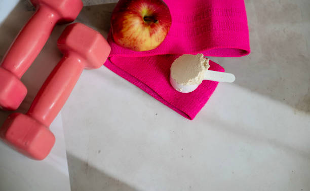 istock Dumbbells and elastic bands on shadows background 2202832865