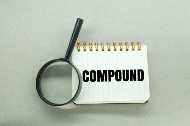 magnifying glass and notebook with the word compound. fined concept\nbusiness, house, construction, building, marketing, finance, success, medicine, science, pharmacy, investment, laboratory, growth, management, financial, apartment, chemistry, economy, wealth, profit, chemical, residential, formula, capital, housing, development, contemporary, compound, landscaping, retirement, progress, interest rate, foreclosure, district, estate, earnings, 401k, compound interest, crises, economic stability, exponential, financial freedom, financial growth, fund, invest, online investment, rich, saving
