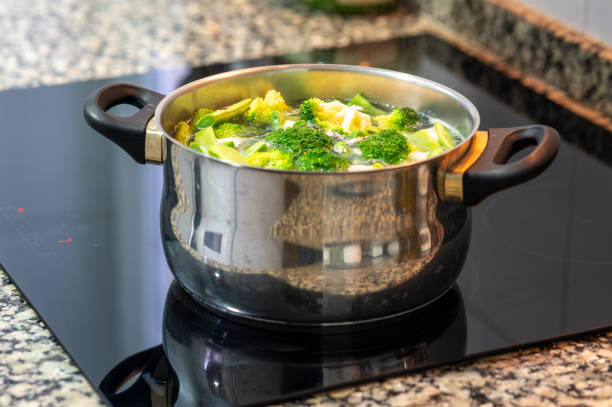istock Broccoli and cauliflower cooking in a pot on a modern vitroceramic stove 2202835932