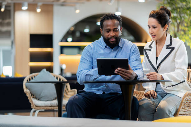 istock Confident entrepreneurs presenting innovative business plan on digital tablet to investment manager in modern office. Professional teamwork discussion analyzing strategy and opportunities for future growth and success. 2202836180