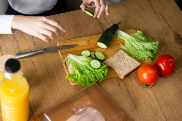istock Young woman making breakfast, hands closeup 2202842400