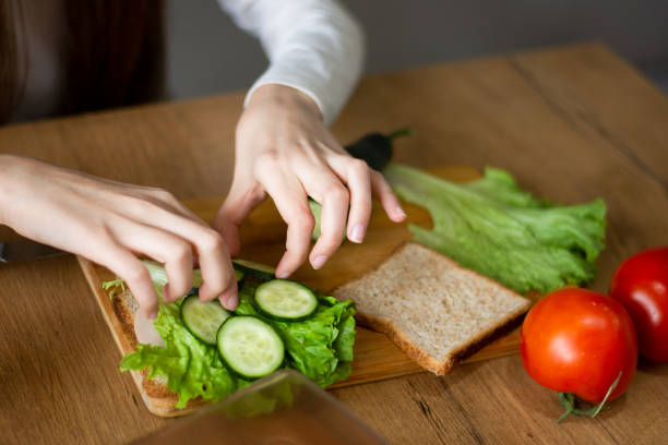 istock Girl with vegetables at kitchen 2202842404