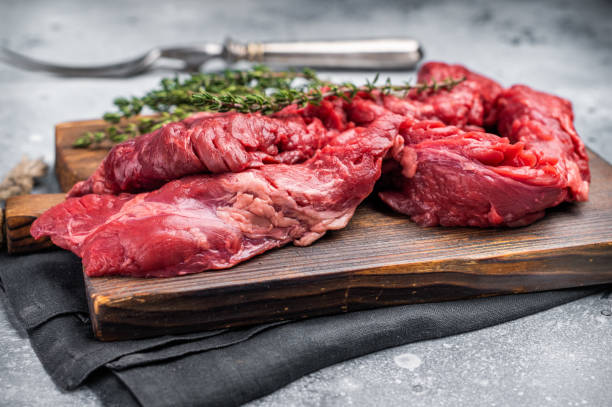istock Uncooked Beef Skirt Steak, also name Machete steak, raw meat on cutting board. grey background. top view 2202843208