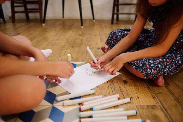 istock Children Coloring on Paper Together 2202843415