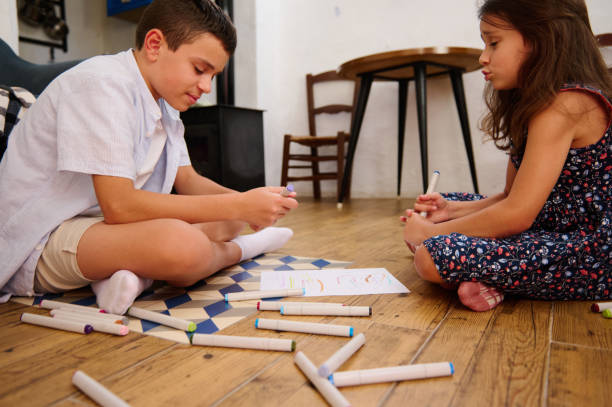 istock Children Drawing Together On The Floor 2202843484