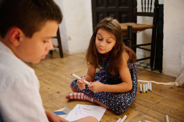 istock Children Drawing Together on the Floor 2202843502
