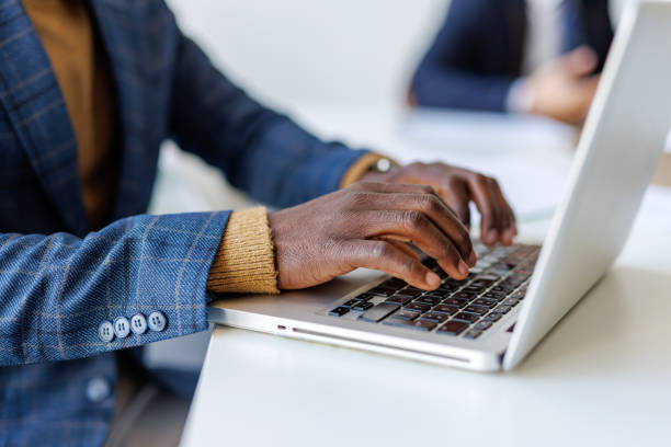 istock Businessman typing on laptop in modern office during meeting 2202844854