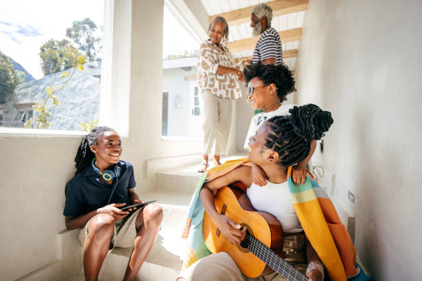 Portrait of grandmother and granddaughter embracing at home