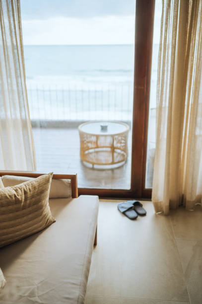 istock luxury beachfront hotel room with panoramic ocean view and cozy seating area relaxing coastal retreat with elegant decor and a stunning sea view 2202846424