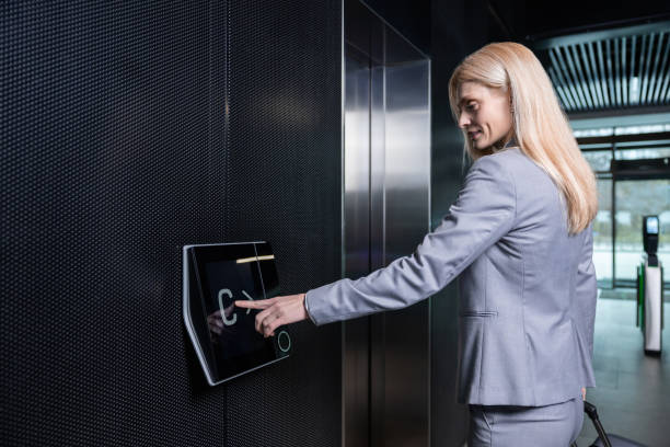 istock Blonde woman in elegant suit waiting for the elevator 2202846919