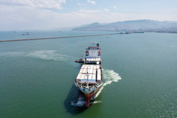 istock A roll on roll off type cargo ship (Ro-Ro) is underway with a tugboat guading. 2202847074