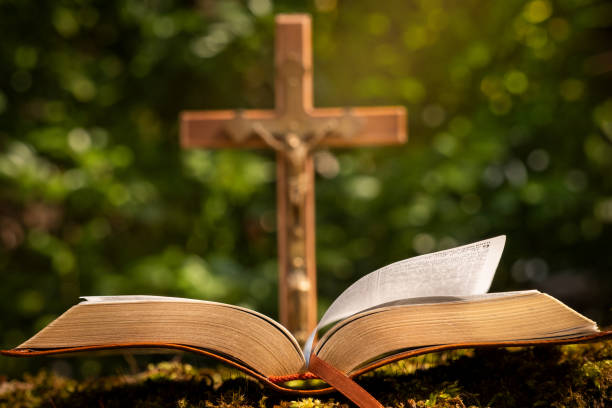 istock Open Bible with Wooden Cross 2202847916