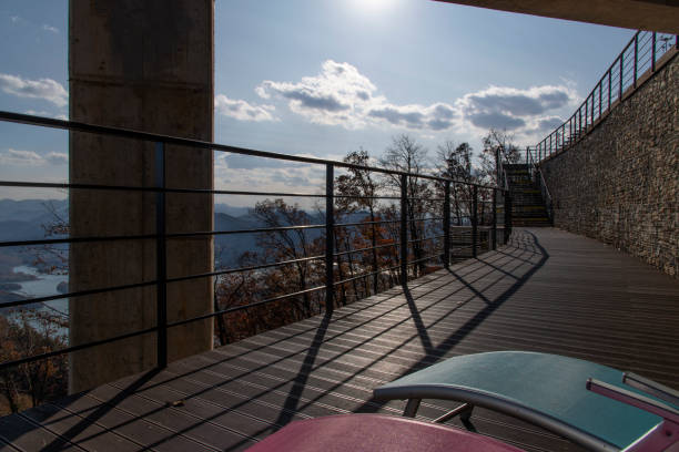 istock boardwalk with chairs and fence on the cliff 2202850604