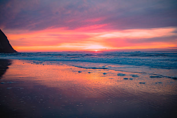 istock Scenic Sunset Over the Ocean with Waves Washing the Sandy Shore 2202851006